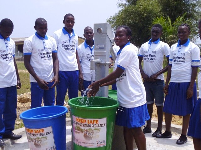 YMCA constrcuted hand pump and sanitation buckets in use